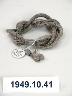 1949.10.41 Bracelet made from Mrs Farrer's plaited and netted grey hair in January 1867. Donated by Pastorella Shelley.